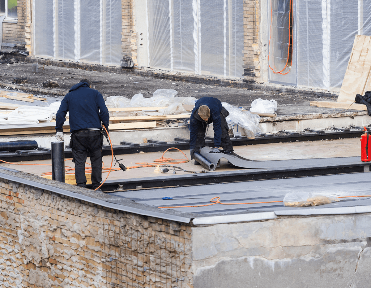 Construction workers on a building roof