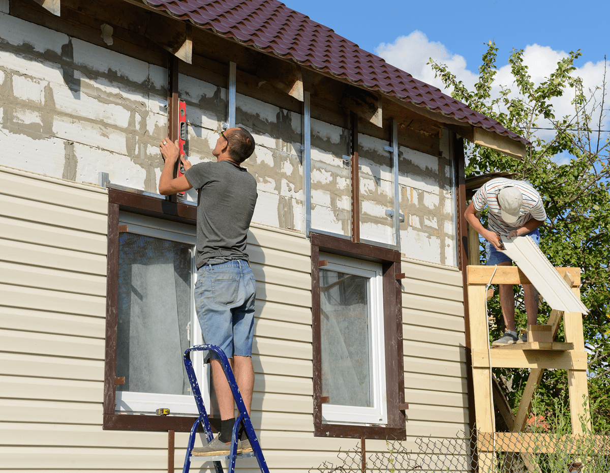 Men working on house siding installation